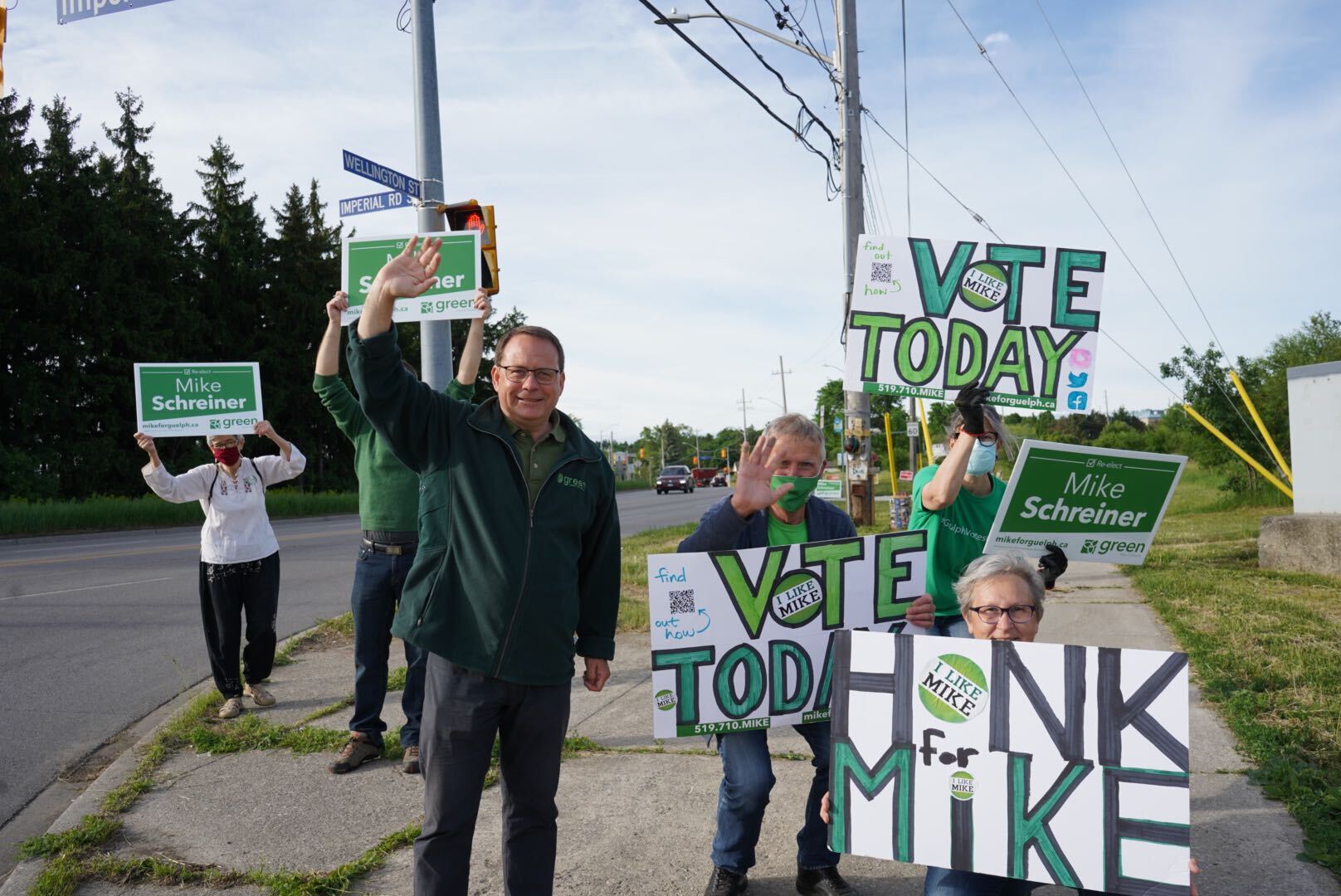 mike with people holding handmade signs